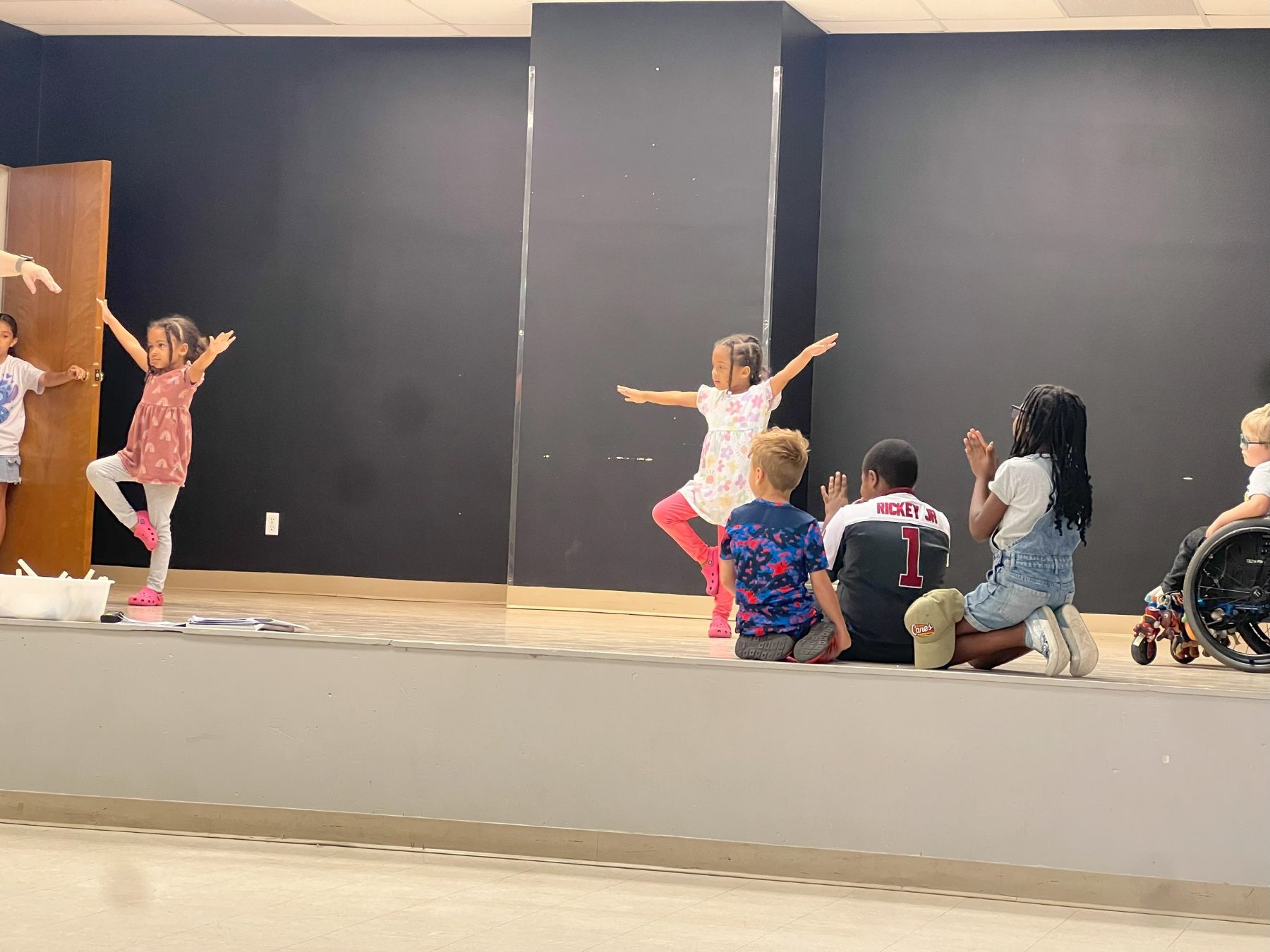 Children dancing or doing a movement activity as part of their enrichment program at Alvani Academy