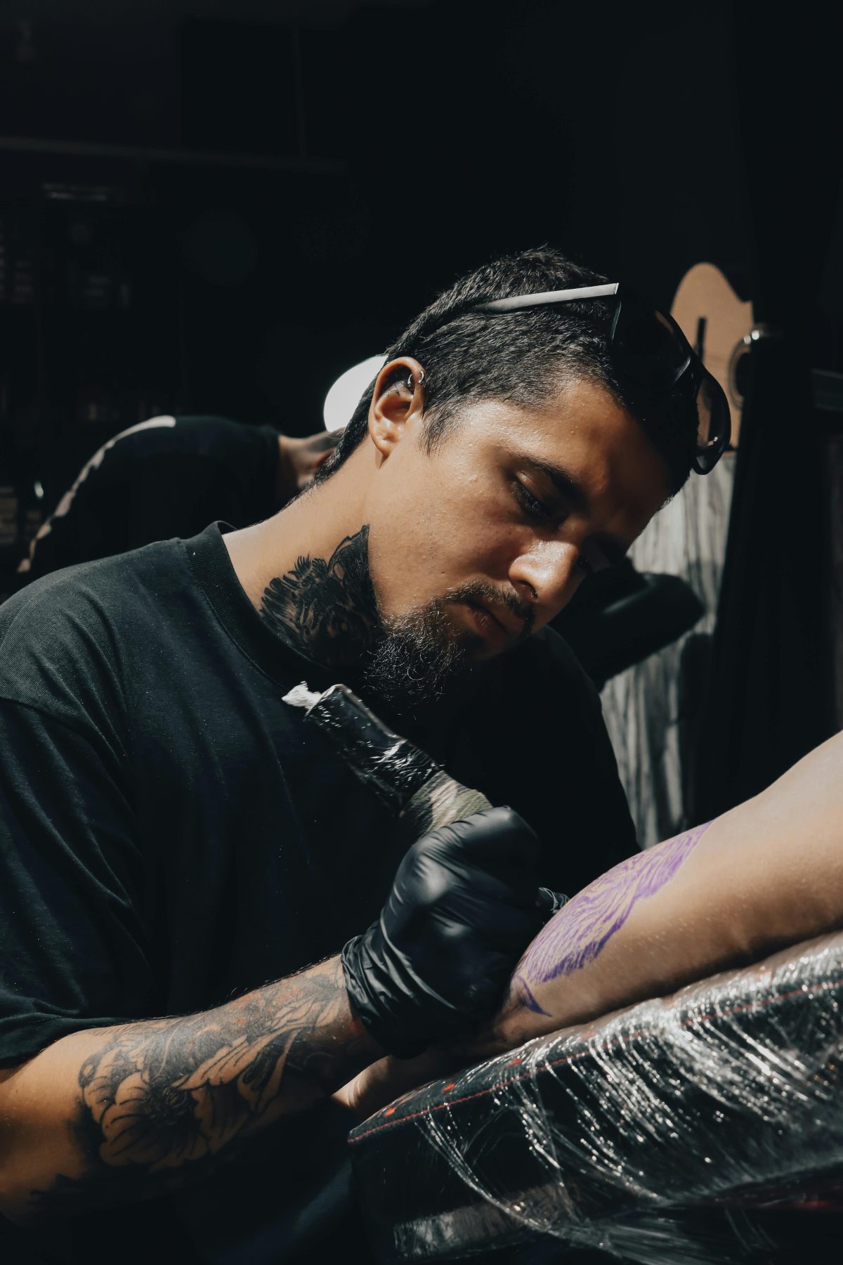 Rook Carter, a Gilded Moth tattoo artist specializing in traditional tattoos, blackwork, and coverups